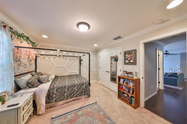 bedroom featuring a textured ceiling, recessed lighting, visible vents, and ornamental molding