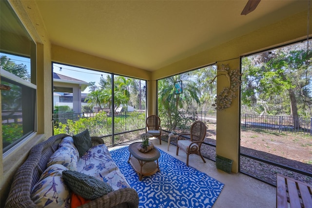 sunroom / solarium featuring a ceiling fan