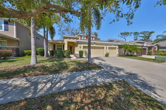 view of front of property with concrete driveway, a garage, and stucco siding