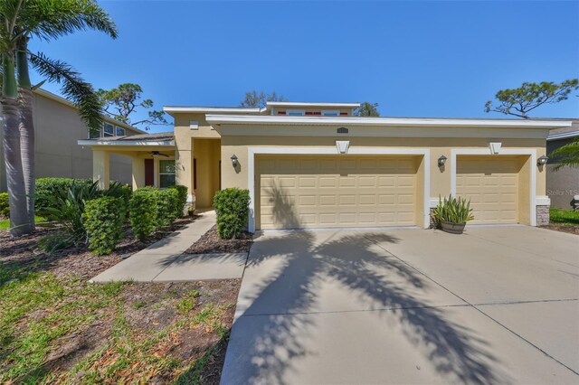 mid-century inspired home featuring an attached garage, driveway, and stucco siding