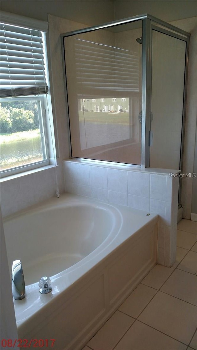 full bath with a garden tub, a stall shower, and tile patterned floors