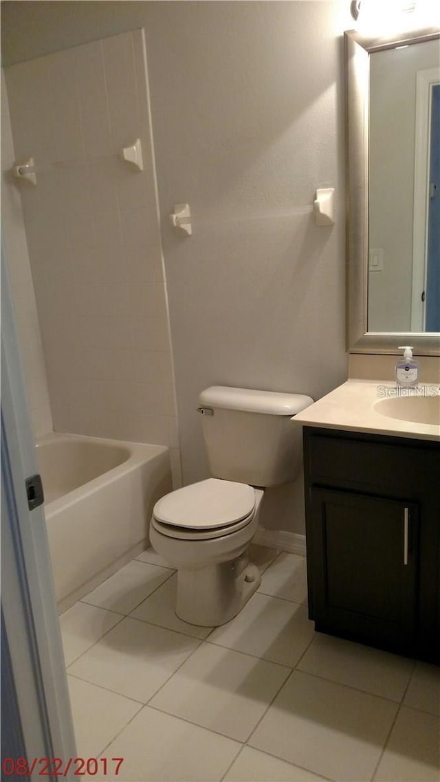 bathroom featuring tile patterned floors, toilet, and vanity