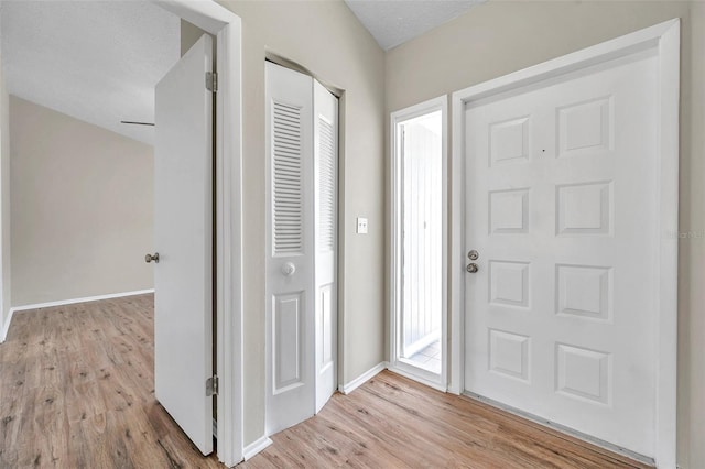 entrance foyer with light wood-type flooring and baseboards