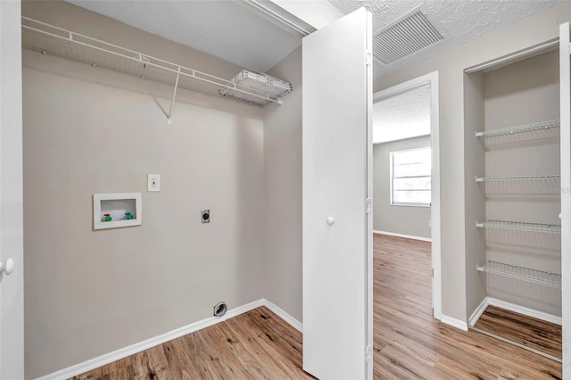 laundry room with visible vents, laundry area, hookup for a washing machine, wood finished floors, and hookup for an electric dryer