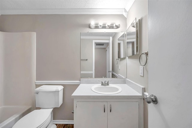 bathroom with vanity, crown molding, toilet, and a textured ceiling