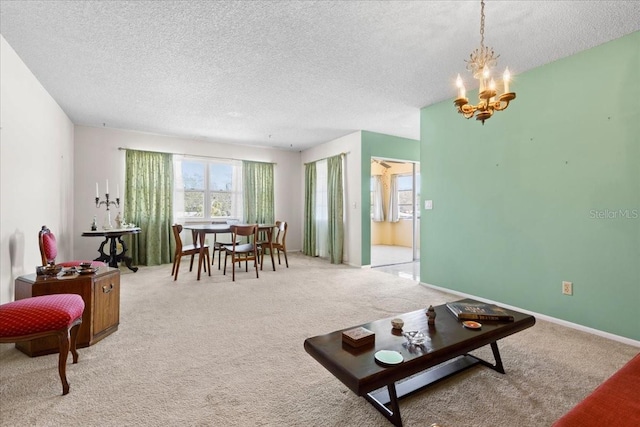 carpeted living area with baseboards, a notable chandelier, and a textured ceiling