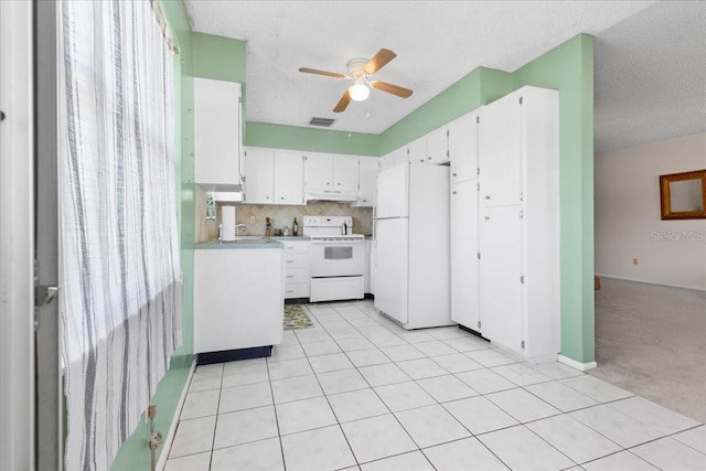 kitchen featuring visible vents, under cabinet range hood, white appliances, white cabinets, and ceiling fan