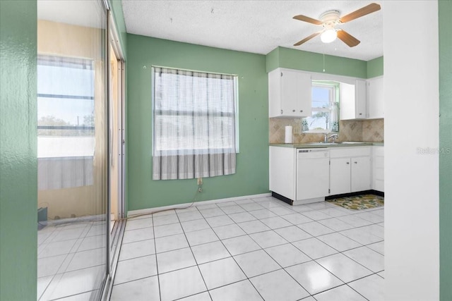 kitchen with a textured ceiling, backsplash, white cabinets, white dishwasher, and ceiling fan