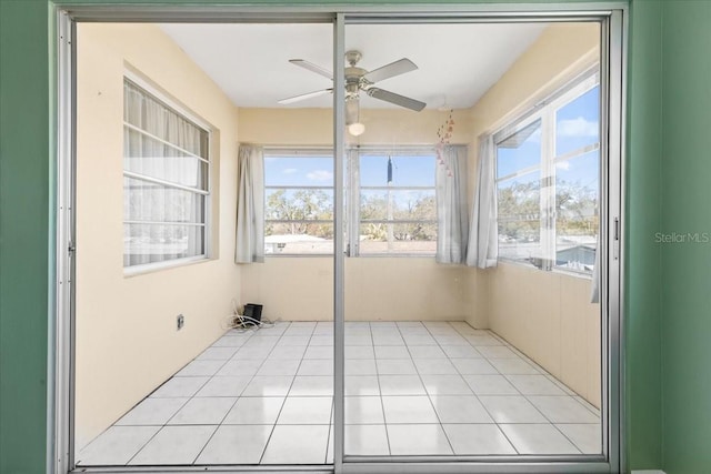 unfurnished sunroom featuring a healthy amount of sunlight and tile patterned flooring