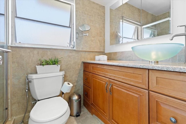full bath featuring toilet, tile walls, a shower stall, tile patterned flooring, and vanity