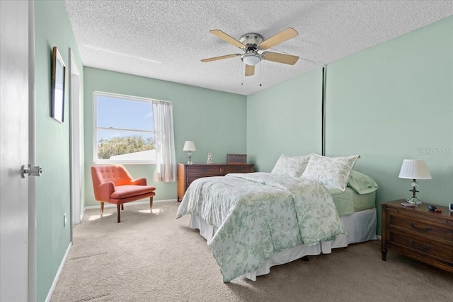 bedroom with baseboards, carpet, and a textured ceiling