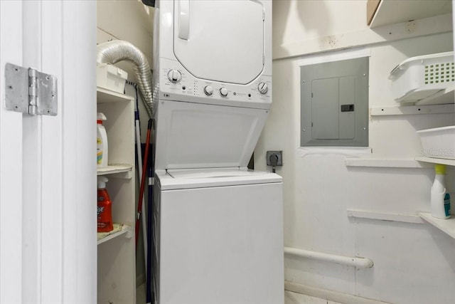 laundry room with laundry area, stacked washer / dryer, and electric panel
