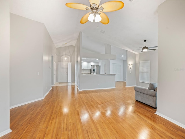 unfurnished living room with ceiling fan, baseboards, light wood-type flooring, and lofted ceiling