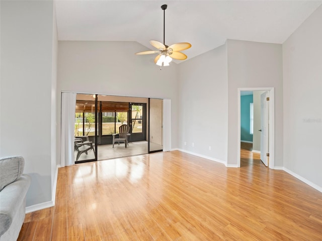 unfurnished living room featuring high vaulted ceiling, ceiling fan, and light wood finished floors