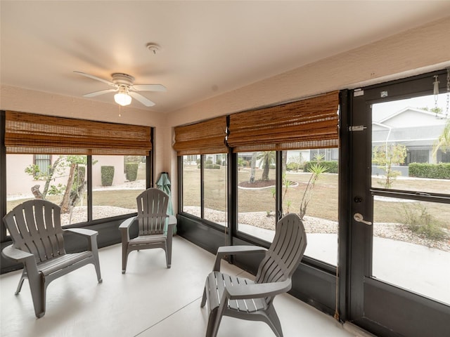 sunroom with a ceiling fan and a wealth of natural light