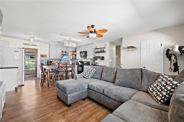 living room featuring wood finished floors and a ceiling fan