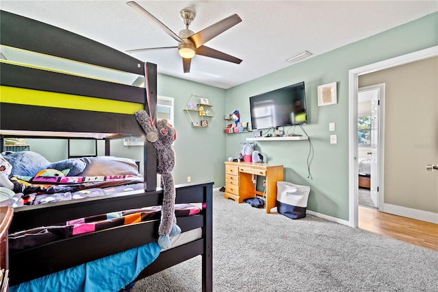 carpeted bedroom featuring visible vents, a ceiling fan, and baseboards