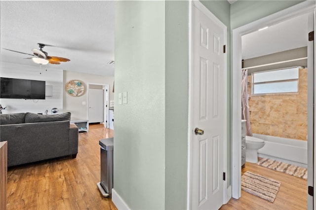 hallway with light wood-style floors and visible vents