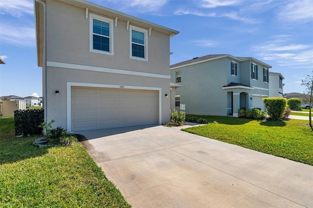 traditional-style house featuring stucco siding, a front lawn, a garage, and driveway