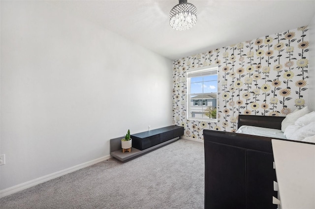 bedroom featuring a chandelier, baseboards, and carpet floors