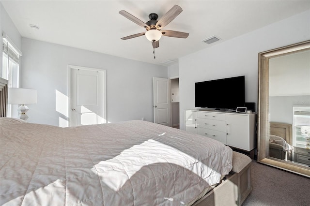 carpeted bedroom featuring visible vents and ceiling fan