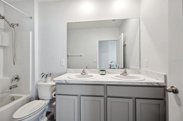 bathroom with double vanity, toilet, bathing tub / shower combination, and a sink