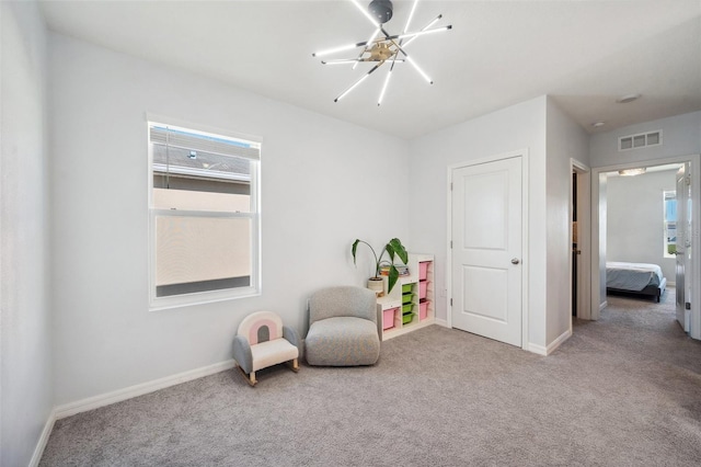 living area with a notable chandelier, visible vents, carpet flooring, and baseboards