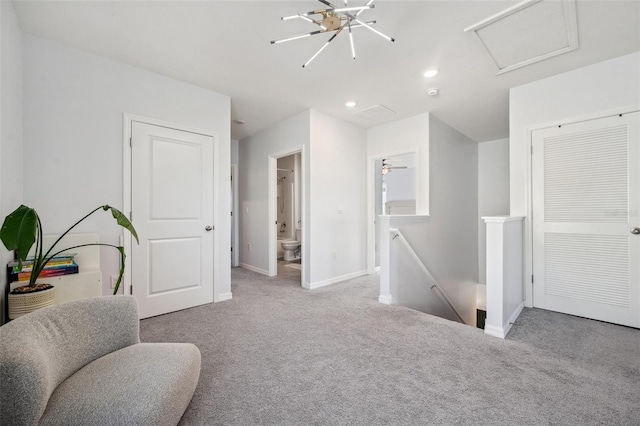 sitting room featuring baseboards, attic access, recessed lighting, carpet flooring, and an upstairs landing