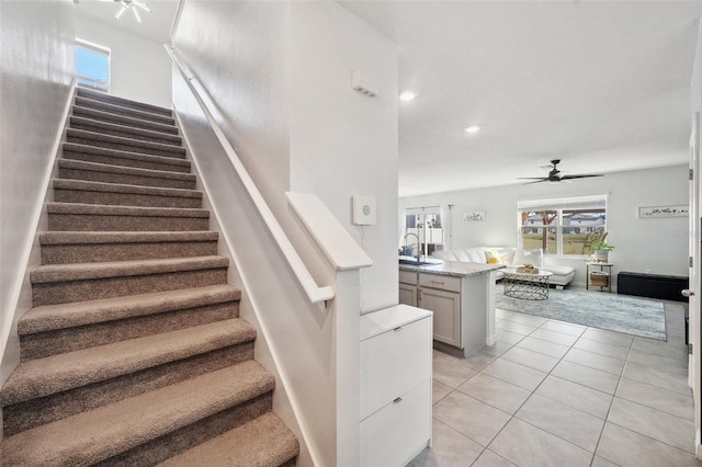 stairway with tile patterned floors, recessed lighting, and ceiling fan