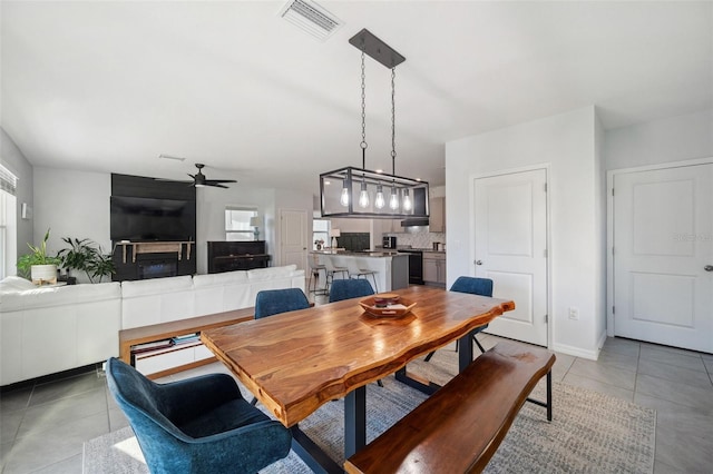 dining area featuring light tile patterned floors, visible vents, and ceiling fan