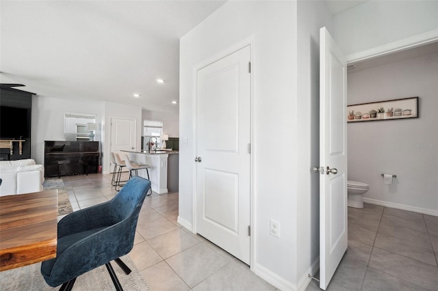 dining room with light tile patterned floors, recessed lighting, and baseboards