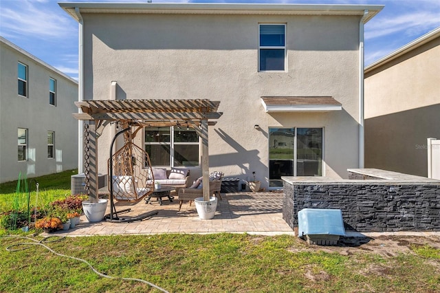 rear view of house with central air condition unit, stucco siding, outdoor lounge area, a patio area, and a pergola