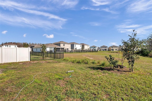 view of yard featuring a residential view and fence