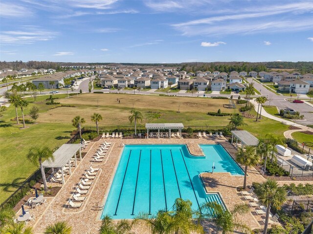 pool with a residential view and a pergola