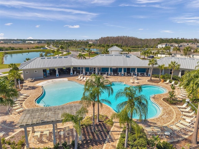 pool with a patio area and a water view