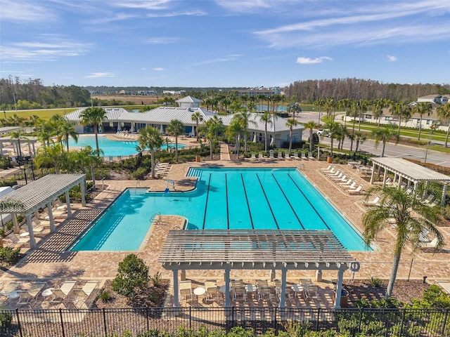 community pool featuring a patio and fence