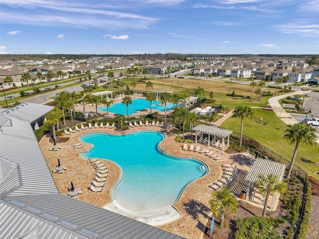 community pool with a residential view, a pergola, a patio, and fence