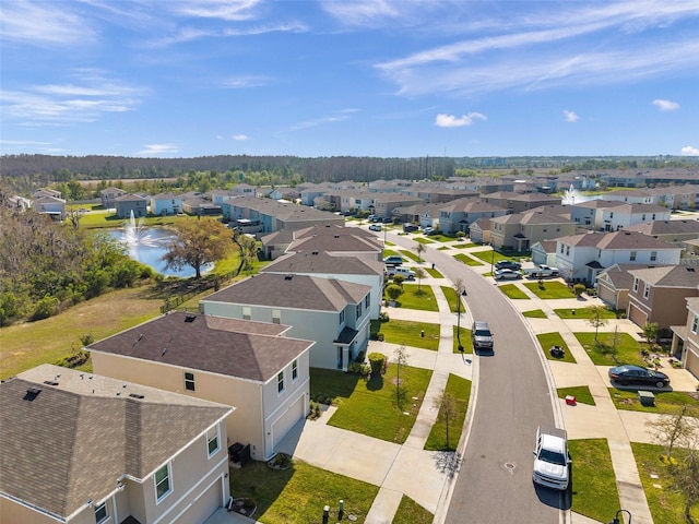 drone / aerial view featuring a residential view and a water view