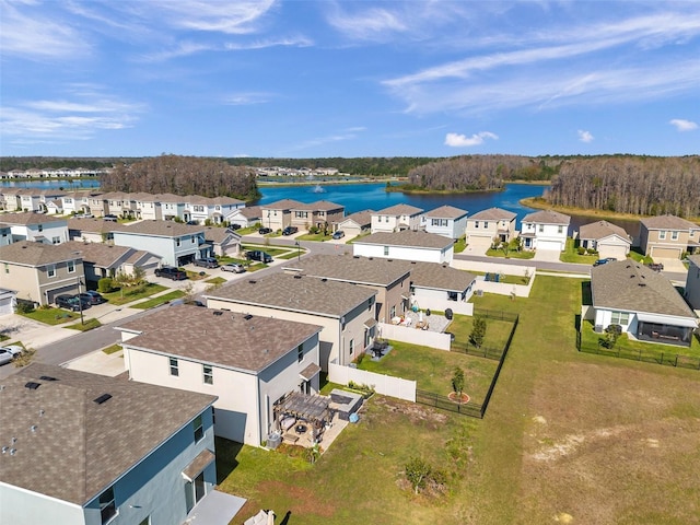 drone / aerial view featuring a residential view and a water view