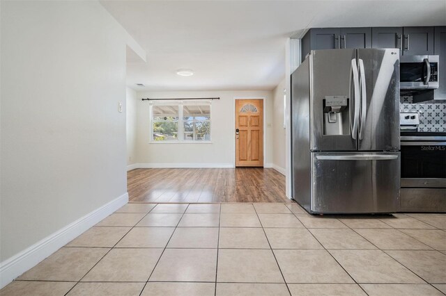 10309 108th Ave, Largo, FL 33773 - kitchen with light tile patterned floors, stainless steel appliances, and baseboards