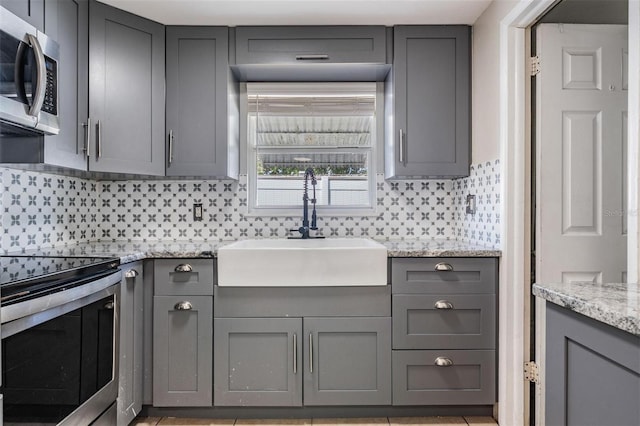 10309 108th Ave, Largo, FL 33773 - kitchen with a sink, stainless steel appliances, and gray cabinetry