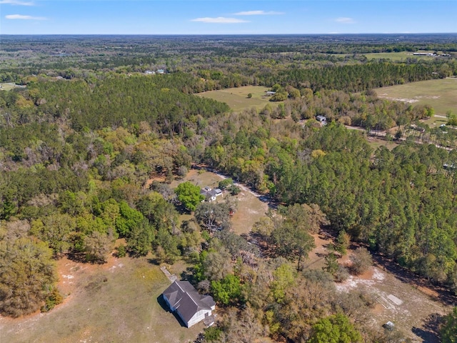 birds eye view of property featuring a wooded view