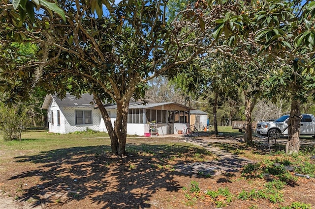 view of yard featuring a sunroom