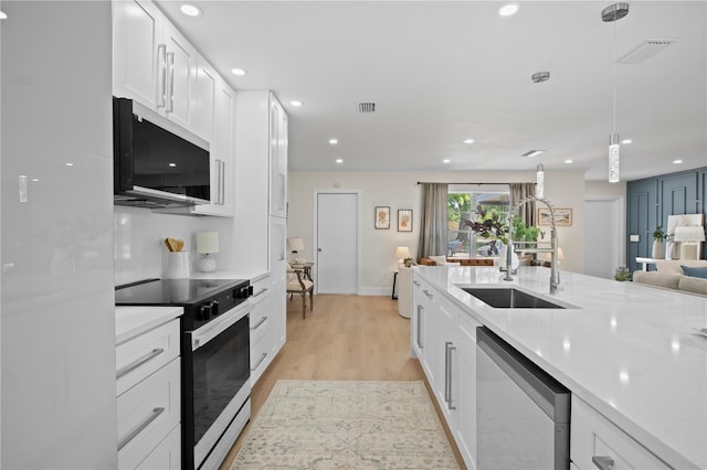 2008 41st St W, Bradenton, FL 34205 - kitchen with visible vents, electric stove, a sink, white cabinetry, and dishwasher