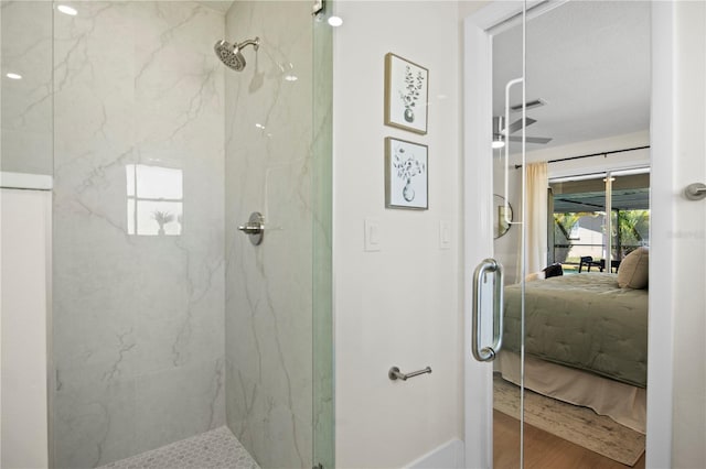 2008 41st St W, Bradenton, FL 34205 - ensuite bathroom featuring a marble finish shower, ensuite bath, and wood finished floors