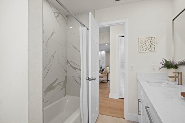 2008 41st St W, Bradenton, FL 34205 - bathroom featuring vanity, wood finished floors, baseboards, and shower / bath combo