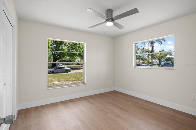 2008 41st St W, Bradenton, FL 34205 - spare room featuring baseboards, a healthy amount of sunlight, and wood finished floors