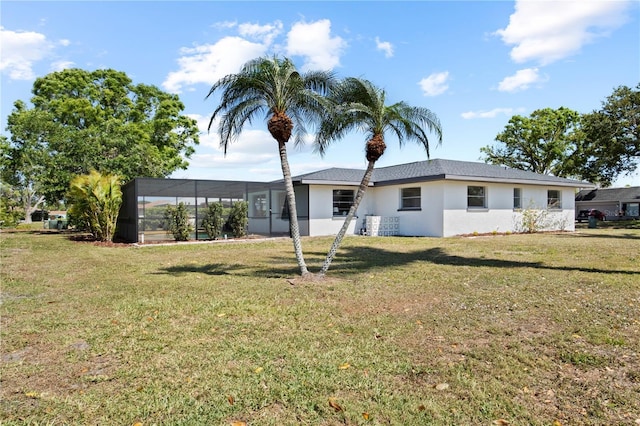 2008 41st St W, Bradenton, FL 34205 - back of property with stucco siding, glass enclosure, and a yard