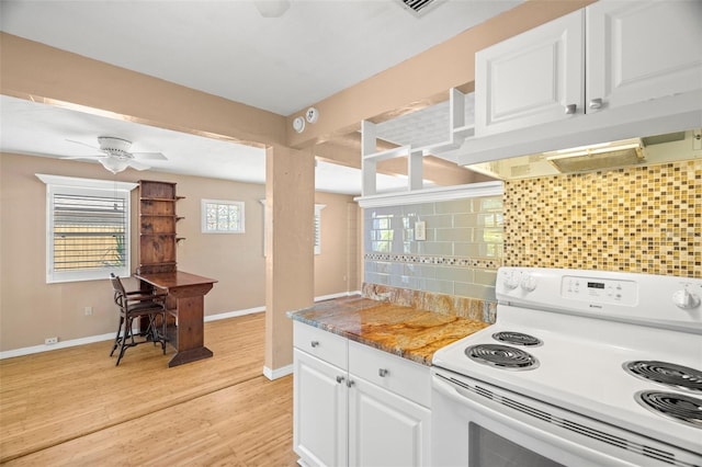 kitchen with white range with electric cooktop, light wood-style flooring, decorative backsplash, under cabinet range hood, and white cabinetry