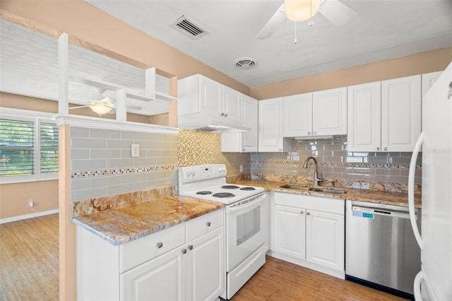 kitchen with a sink, visible vents, white appliances, and a ceiling fan